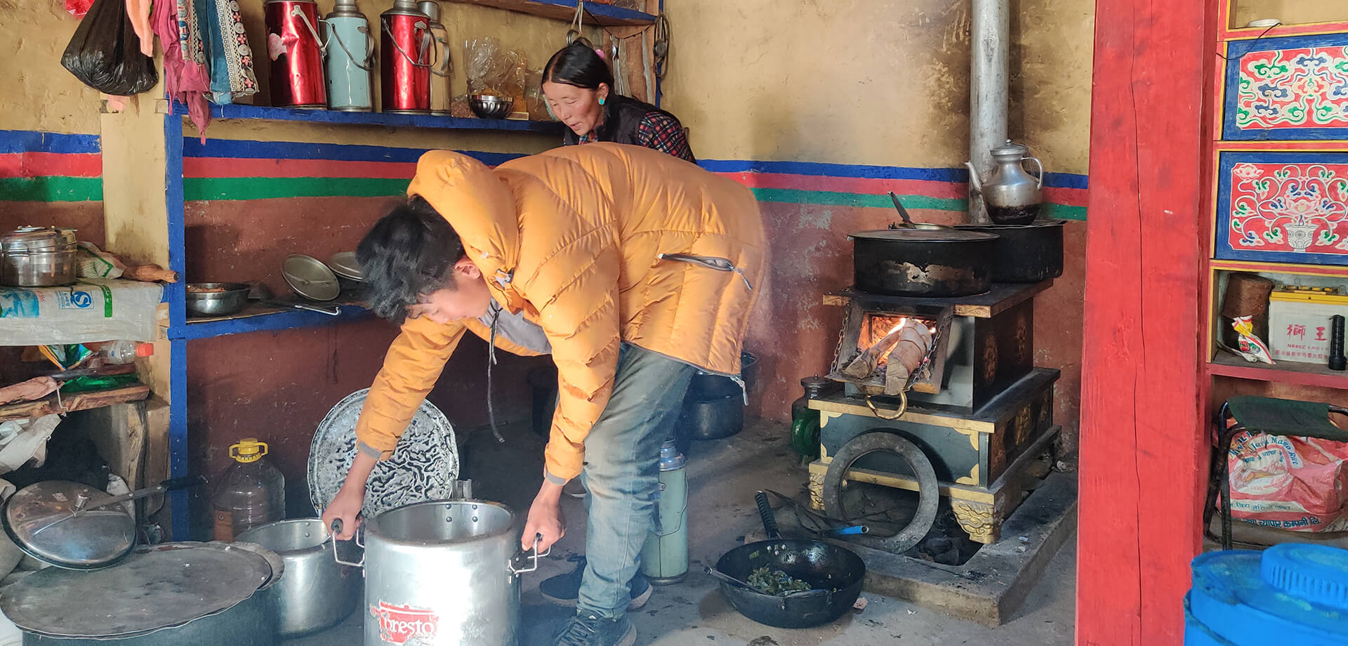 Shopkeepers cooking local cuisine on open stoves
