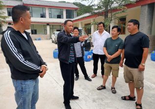 He Shijian (middle), chief of Jiazi village