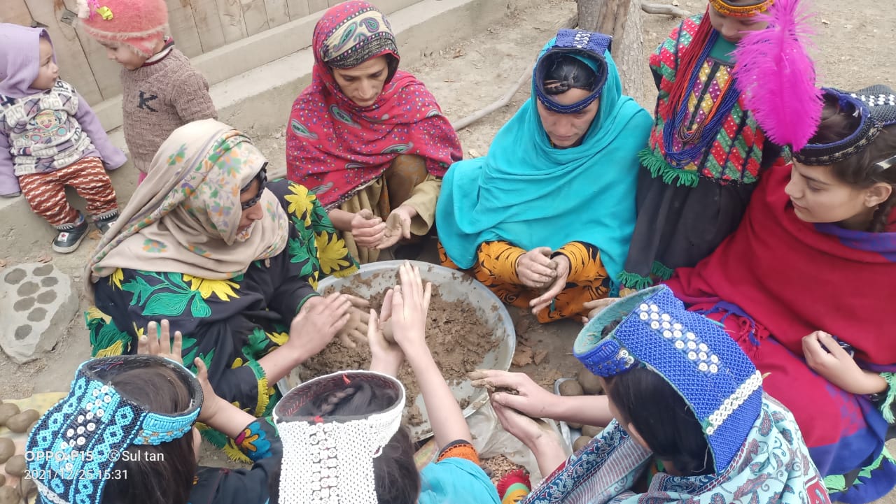 Women preparing seed balls