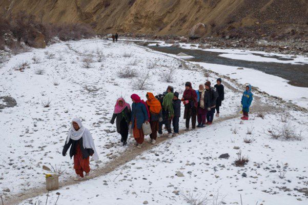 way back home after filling their water cans